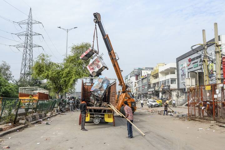 A visual from Shaheen Bagh area where crane was used to clean the streets after removing demonstrators continuously protesting against a new citizenship law, while the government imposed a lockdown as a preventive measure against the COVID-19 novel coronavirus in New Delhi on March 24, 2020. (Photo by Sajjad HUSSAIN / AFP)
