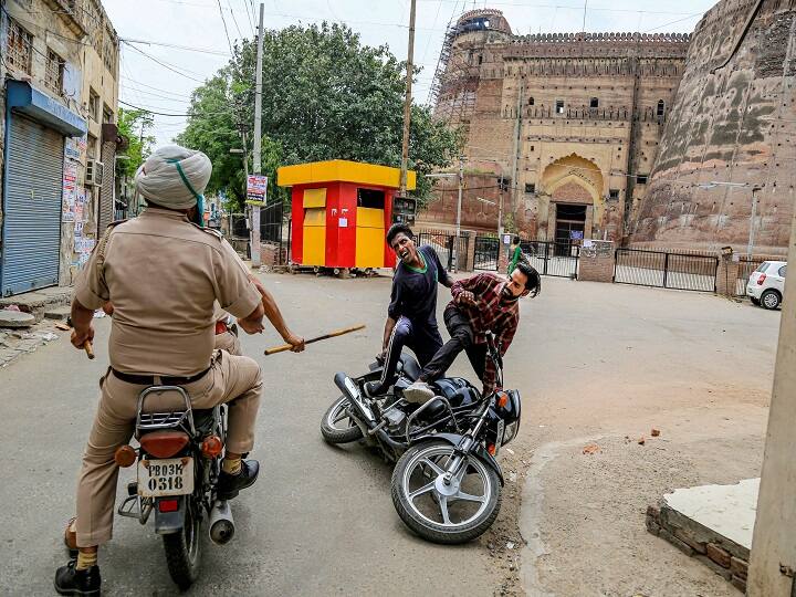 Bathinda: Police personnel charge at a biker for flouting lockdown guidelines, imposed in the wake of coronavirus pandemic, near Razia Sultana Fort in Bathinda, Tuesday, March 24, 2020. (PTI Photo) 
