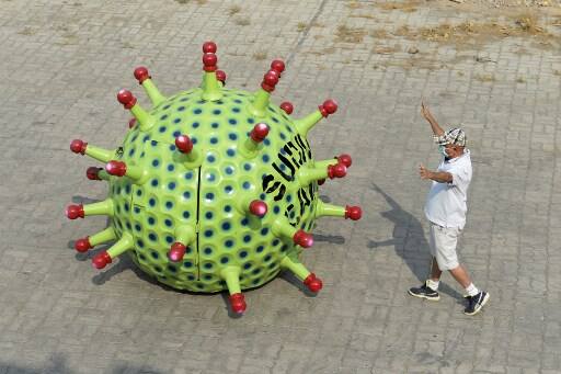 Coronavirus has made warriors out of the common man. Everyone is pitching in to help spread awareness about the infection. One of them is the automobile museum owner from Hyderabad, Kanyaboyina Sudhakar. (Photo by NOAH SEELAM / AFP)