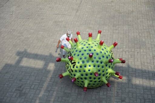 Sudhakar is known for his ‘wacky cars ‘and has been developing customized cars for social causes for some time now. He created a condom-shaped bike to spread awareness on AIDS, helmet-shaped car for head safety and cigarette-shaped bike for smoking. The corona car is not for sale. (Photo by NOAH SEELAM / AFP)