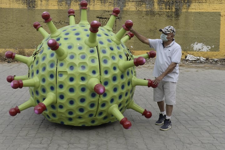He follows suit after Chennai cop Rajesh Babu who created Corona helmet and a couple in Chattisgarh who named their twins Corona and Covid(Photo by NOAH SEELAM / AFP)