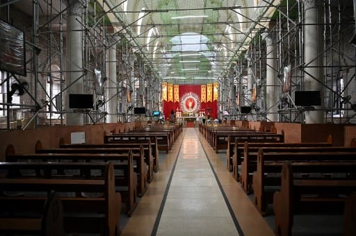 General view of an empty parish church with photos of parishioners taped as part of social distancing measures amidst the COVID-19 pandemic in Angeles City in Philippines. (Photo: AFP)