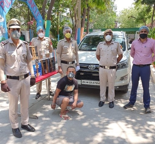 A man has been arrested with four cartons of illegal foreign imported liquor & 60 boxes of cigarettes in Kalkaji area in Delhi. (Photo: ANI)
