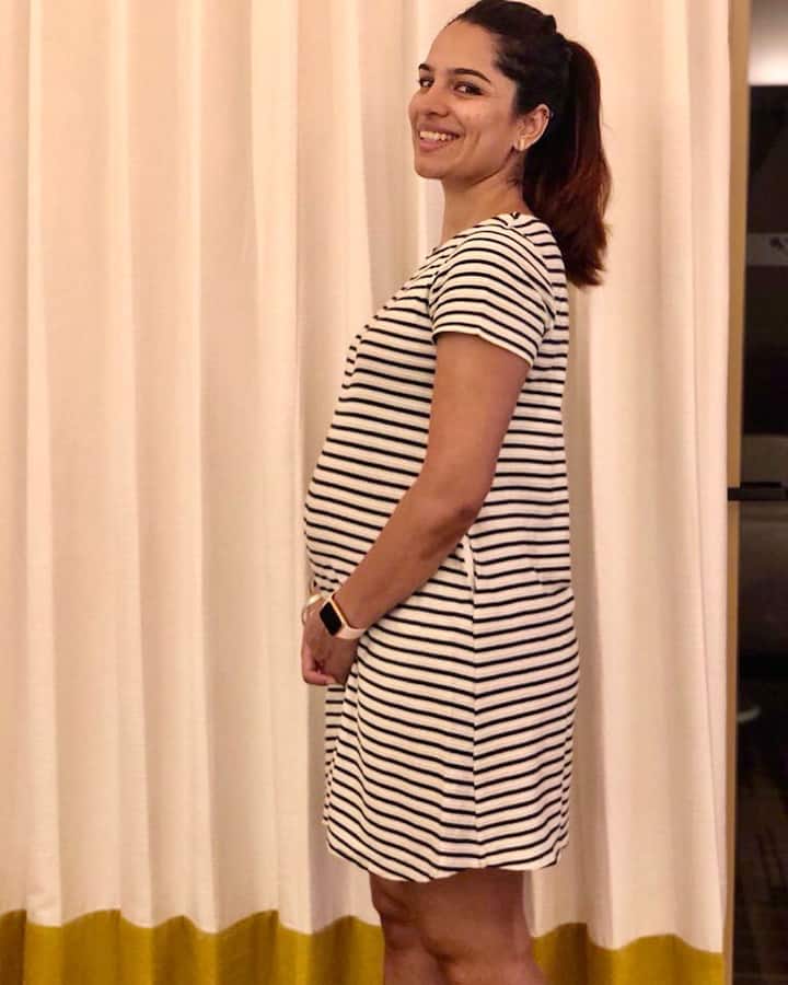 Shikha shared several photos in which she can be seen flaunting her baby bump in a striped dress.
