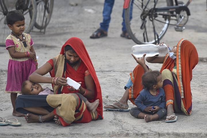 While the government is running special trains to send the migrant workers back to their homes, many of them have decided to travel by foot. While some are still waiting to see their names appear on the list of trains that are being run by the Railways, others are walking bare-foot to reach their homes. (Photo Credit: AFP)
