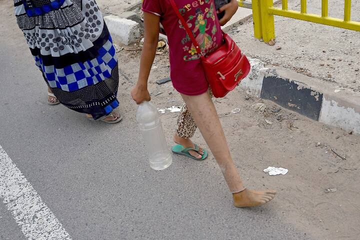 Young children, who should be at their homes, are forced to travel along with their parents. (Photo Credit: AFP)