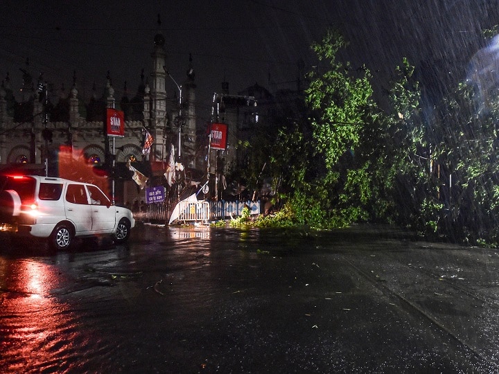 Kolkata: A tree uprooted blocks a road during heavy rain after the landfall of super cyclone 'Amphan', infront Tipu Sultan Masjid in Kolkata. (Image: PTI)