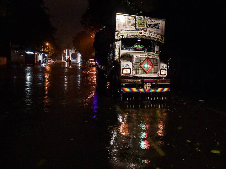 Vehicles ply on a water-logged road during rain after the landfall of super cyclone 'Amphan', in Kolkata. (Image: PTI)