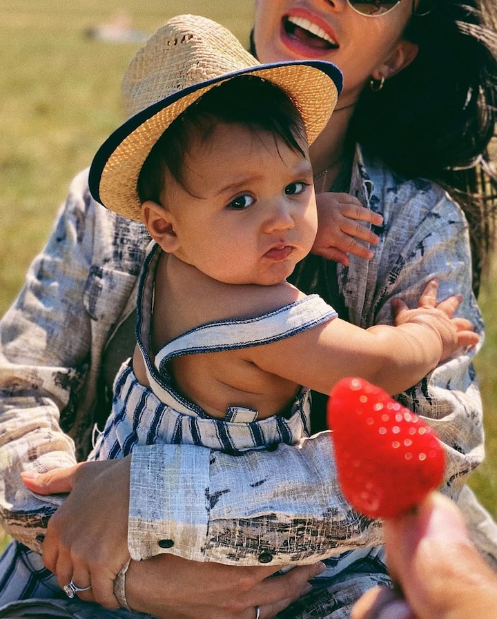 Amy Jackson can be seen having a hearty laugh while holding her baby boy in her arms.