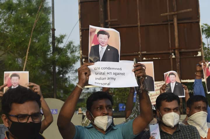 Protesters raise placards registering their outrage against Chinese premier Xi Jinping. PIC/ANI
