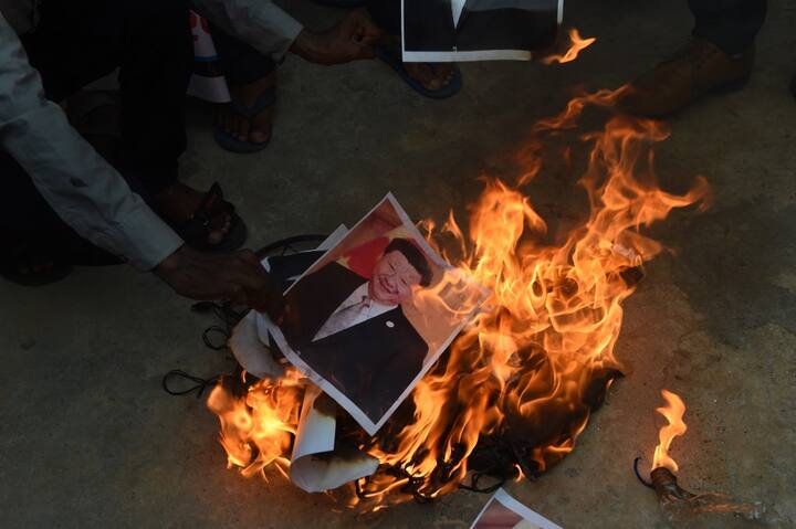 Chinese President Xi Jinping's posters being burnt by angry protesters. PIC/ANI