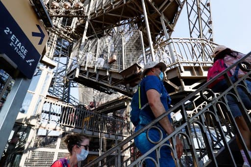 The reopening of the Eiffel Tower has made the people super excited.  Here’s a photo of visitors walking up the stairs to the second floor (Photo by Thomas SAMSON / AFP)