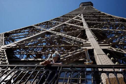 Tourists and Parisians expressed their joy on social media as the Eiffel Tower reopened after its longest closure since World War II due to the COVID-19 pandemic. As a precautionary measure, the authorities have decided to not use the lifts facility. (Photo by Thomas SAMSON / AFP)
