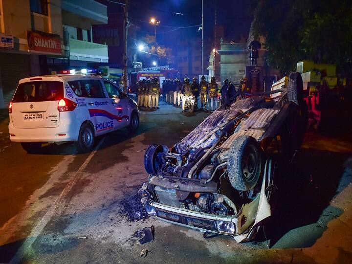 Bengaluru: Charred remains of a vehicle vandalised by a mob, in Bengaluru, Wednesday morning, Aug. 12, 2020. A mob rampaged through Bengaluru's Pulakeshi Nagar Tuesday night and vandalised a police station and a Congress legislator Akhanda Shrinivasa Murthy residence after an alleged relative of the MLA shared a social media post purportedly on a communal issue. The incident took place at Kaval Byrasandra in Bengaluru, outside Pulkeshinagar Congress MLA R Akhanda Srinivas Murthy’s house. Later hundreds more gathered and marched to DJ Halli police station, setting vehicles outside the police station on fire, and chanting slogans demanding an FIR and immediate arrest of Murthy's relative. PIC/PTI