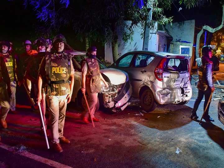 Atleast three people were killed after police opened fire to quell a mob that went on a rampage. Scores of persons, including around 50 policemen, were injured in the violence. One of the victims has been identified as Yasin Pasha. The victim's father Afzal told reporters that his son was 'innocent.' Meanwhile, curfew has been imposed in the affected areas in and around DJ Halli and KG Halli. Police walk past damaged vehicles vandalised. PIC/PTI