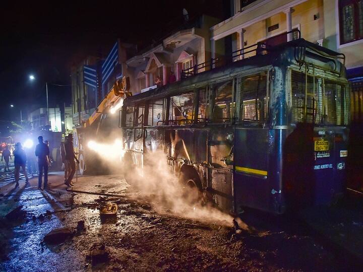 Bengaluru: Charred remains of a vehicle vandalised by the mob. Local reports say Srinivas Murthy said he was not at home when the incident took place. He later shared a video on social media, requesting people to maintain peace and harmony. PIC/PTI