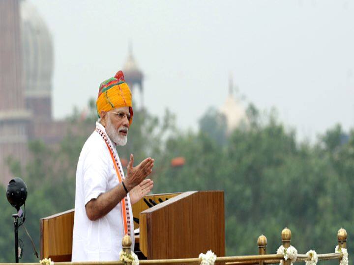 In 2019, returning with a huge mandate, PM matched the Indian flag. While he chose to keep his style of turban consistently Rajasthani, in shades of orange and green, his white kurta was offset by a patterned orange seam running down its centre. (Getty Images)