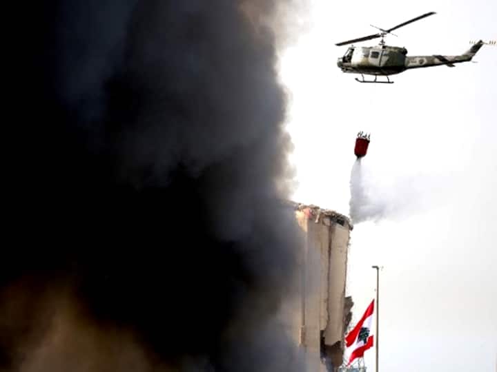 A Lebanese army helicopter pours water over a huge fire in the capital Beirut's seaport on September 10, 2020. (Photo by PATRICK BAZ / AFP)