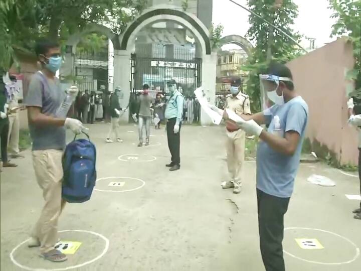 Bihar: Visual show people maintain social distancing norms as they arrive early for the exams.(ANI Photo)