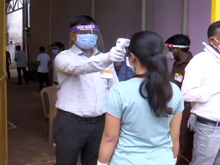 Chhattisgarh: Temperature of candidates being checked and social distancing norms being followed at an exam centre in Raipur. (ANI Photo)