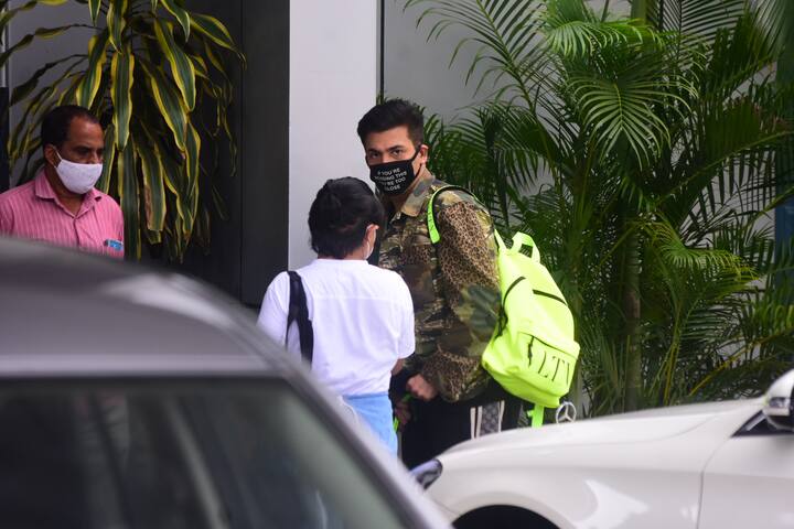 Karan Johar was spotted in a camouflage jacket while entering the airport. He wore a mask on his face as a precautionary measure against COVID-19.