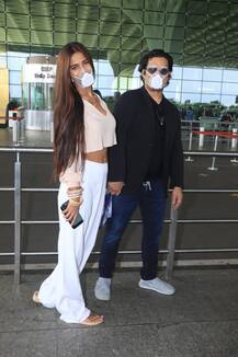 IN PICS: Newly Married Poonam Pandey Flaunts Sindoor, Manglasutra & Chooda At The Airport While Posing With Husband Sam Bombay
