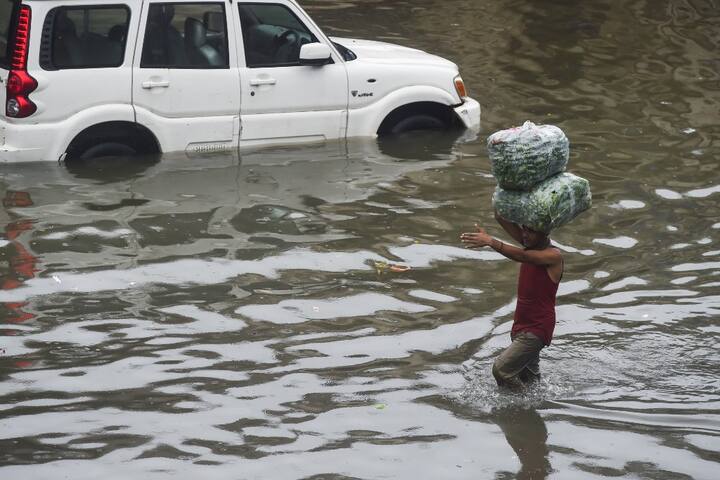 Rains across the island city and the western suburbs picked up late Tuesday evening. There were intense spells across Mumbai for a few hours overnight. According to IMD, the city recorded over 12.20 cms rain while the suburbs notched over 27.50 cms rain most of it during the night. (Image: AFP)