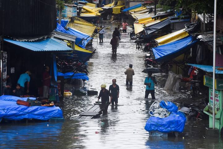 As per latest updates, the heavy downpour has led to waterlogging in many parts of the metropolis on Wednesday, prompting disruption of road and rail traffic. Even public transport services were hit and normal life affected in the financial capital due to heavy downpour and waterlogging. (Image: AFP)