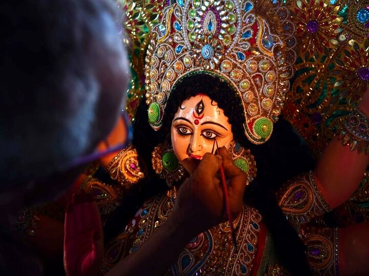 An artisan gives finishing touches to a clay sculpture depicting Hindu goddess Durga at a workshop ahead of the upcoming 'Durga Puja' festival, in Guwahati. Biju BORO / AFP