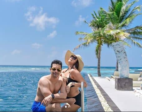 Neha looked gorgeous in a black bikini, which she paired with a beach sun hat, while Angad Bedi can be seen sporting blue shorts.