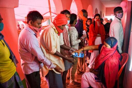 Among other Covid-19 precautions the EC has also made face mask mandatory, temperature checks will also be done at every polling station and it will be disinfected at regular intervals. Image (AFP)