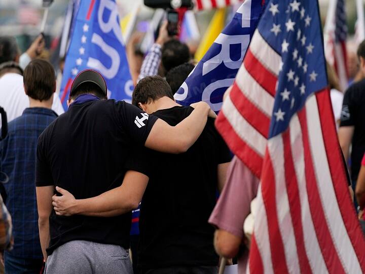 Phoenix : Supporters of President Donald Trump pause in prayer at a rally outside the Maricopa County Recorder's Office Friday, Nov. 6, 2020, in Phoenix. AP/PTI (AP06-11-2020_000256B)