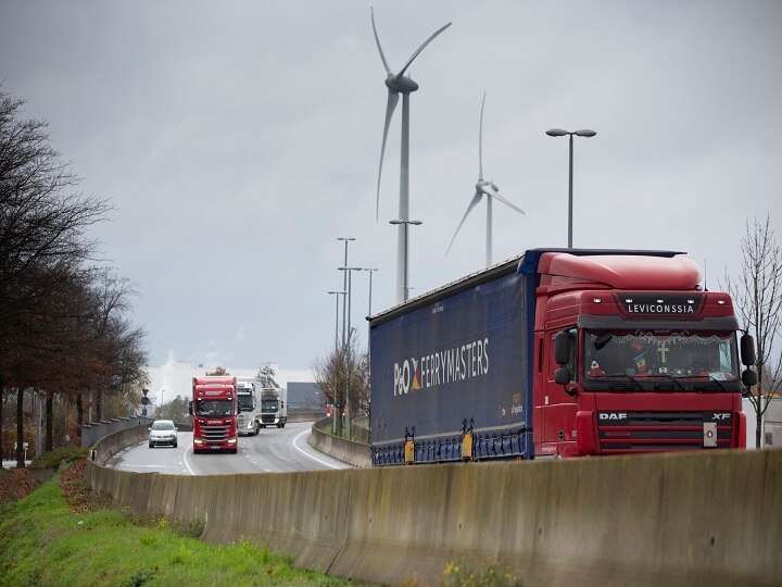 Trucks drive down a motorway outside the Pfizer Manufacturing plant in Puurs, Belgium last week. British officials on Wednesday authorized a COVID-19 vaccine for emergency use, greenlighting the world's first shot against the virus. (Image: PTI)
