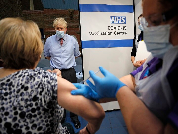 British Prime Minister Boris Johnson watches as nurse Rebecca Cathersides administers the Pfizer-BioNTech COVID-19 vaccine to Lyn Wheeler at Guy's Hospital in London, Tuesday, Dec. 8, 2020. (Image: PTI)