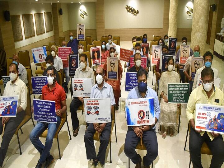Doctors of Indian Medical Association (IMA) hold placards during a protest, demanding the withdrawal of CCIM notification, at IMA House in Kochi, Friday, Dec. 11, 2020. In the notification, Centre has allowed Post Graduate (PG) students of Ayurveda to perform a variety of general surgery including orthopedic, ophthalmology, ENT and dental procedures. (Image: PTI)