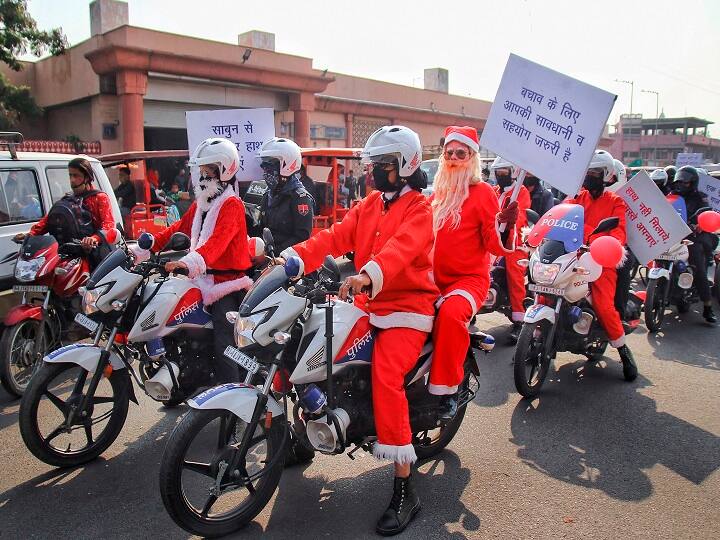 Security personnel of 'Nirbhiya Squad', wearing Santa Claus costumes, take out an awareness rally against COVID-19 on the eve of Christmas, outside St. Andrew Church in Jaipur. (Image: PTI)