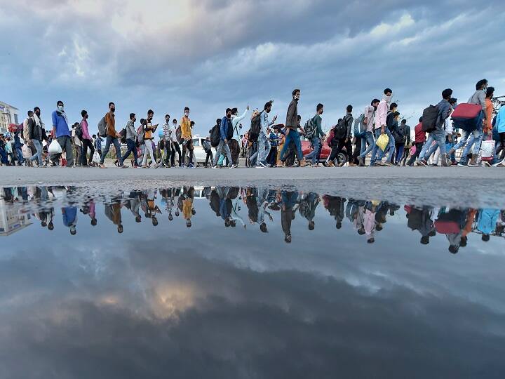 A group of migrant workers walk to their native places amid the nationwide complete lockdown, on the NH24 near Delhi-UP border in New Delhi in March. (Image: PTI)