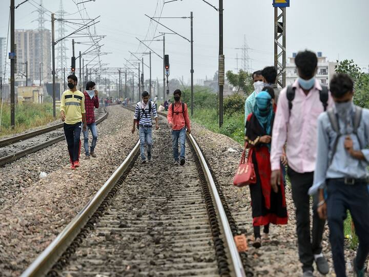 Migrant workers walk on railway tracks after they couldn't find any transport to return to their native places, during a 21-day nationwide lockdown to limit the spread of coronavirus, in Ghaziabad in March. (Image: PTI)
