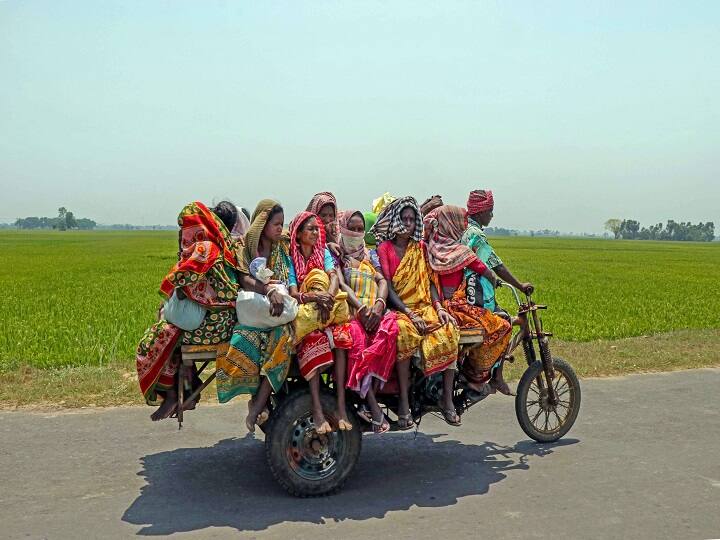 Villagers travel in a crowded three-wheeled vehicle after collecting essential items, during the nationwide lockdown to curb the spread of coronavirus, in Birbhum district in April. (Image: PTI)
