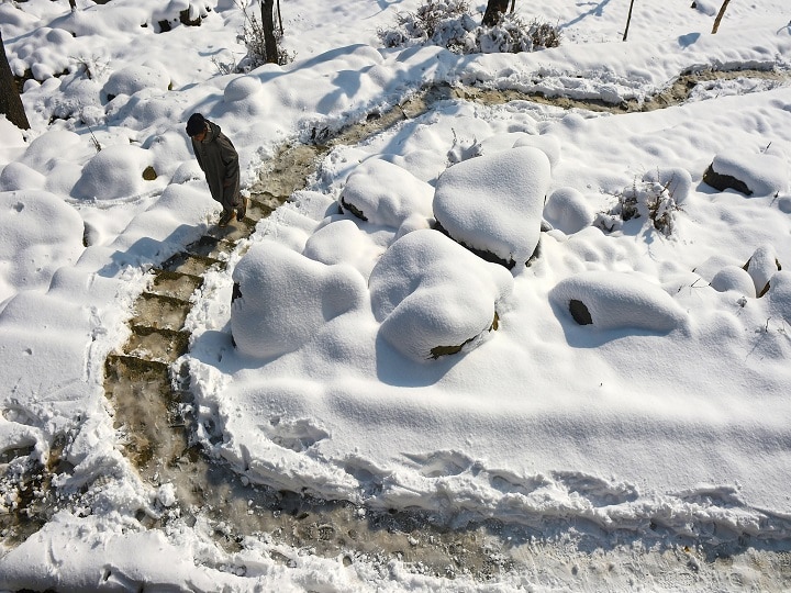 A boy walks on a snow covered stairs after fresh snowfall at Tangmarg in Baramulla District of north Kashmir. Ski-resort of Gulmarg in north Kashmir recorded seven inches of fresh snowfall, while Pahalgam resort in the south and Sonamarg resort in central Kashmir received around three to four inches of snow each. (Image: PTI)