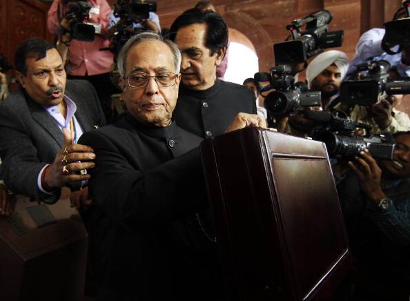 Former President and Finance Minister Pranab Mukherjee with his Deputy Namonarain Meena arrives at Parliament to present the budget 2012-13 on March 16, 2012 in New Delhi, India. Pranab Mukherjee presented his seventh budget. (File Photo/ Getty)