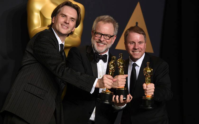 Byron Howard, from left, Rich Moore and Clark Spencer pose in the press room with the award for best animated feature film for "Zootopia" at the Oscars on Sunday, Feb. 26, 2017, at the Dolby Theatre in Los Angeles. (Photo by Jordan Strauss/Invision/AP)
