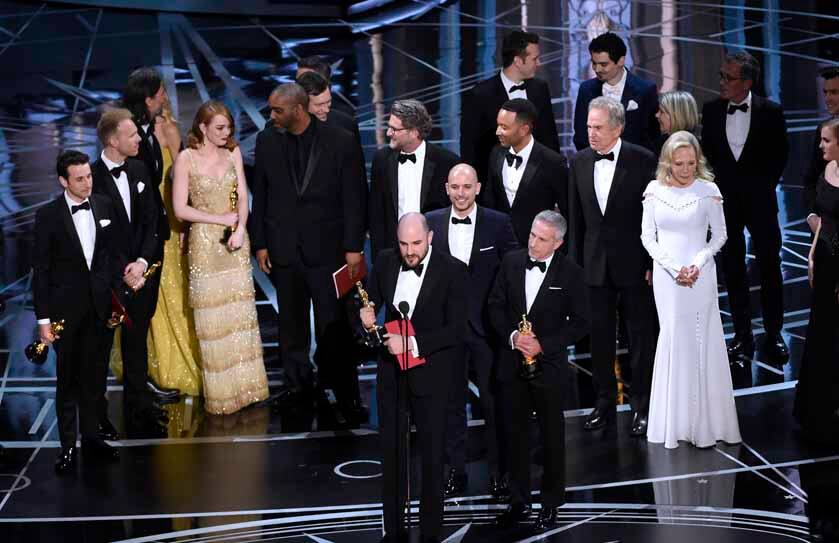 Jordan Horowitz, foreground center, and the cast of "La La Land" mistakenly accept the award for best picture at the Oscars on Sunday, Feb. 26, 2017, at the Dolby Theatre in Los Angeles. It was later announced that "Moonlight," was the winner for best picture. (Photo by Chris Pizzello/Invision/AP)
