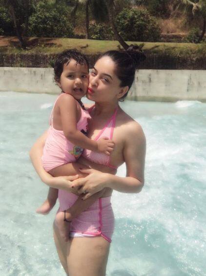 माही ने अपनी बेटी खुशी को अपनी गोद में लेकर पानी के पास खड़े होकर तस्वीर क्लिक करवायी है.