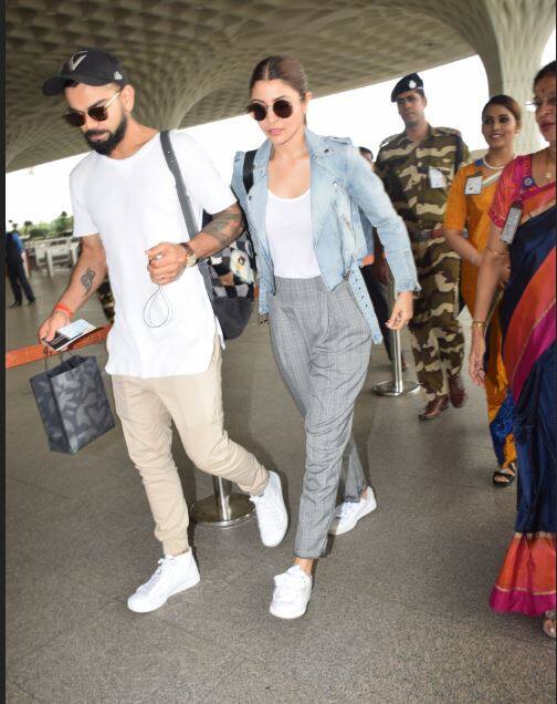 एयरपोर्ट पर अनुष्का और व‍िराट कैजुअल अवतार में द‍िखे. अनुष्का ने ट्राउजर और डेन‍िम जैकेट में थीं तो वहीं व‍िराट कोहली ट्राउजर औप टी-र्शट में थे. (Photo: Manav Mangalani)
