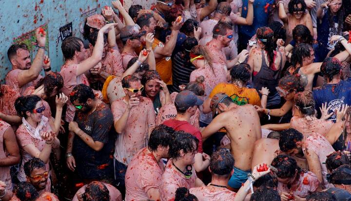 जब से इसकी शुरुआत हुई है तब से ही स्पेन के शहर की सड़कों और गांवों में टमाटर के बने जूस और पल्प से एक दूसरे के ऊपर फेंककर त्योहार को सेलिब्रेट किया जाता है. तस्वीर: एपी 