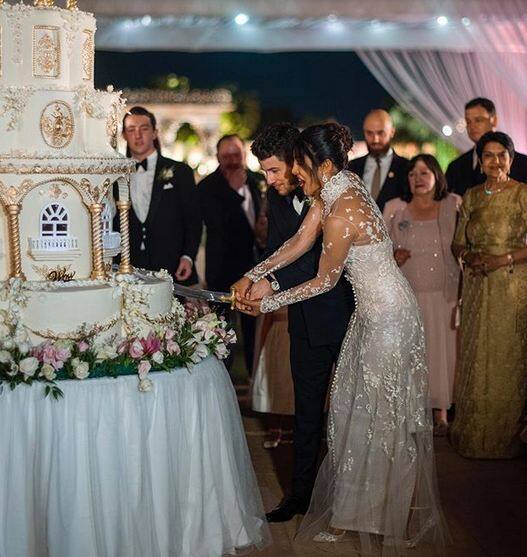 बॉलीवुड एक्ट्रेस प्रियंका चोपड़ा और अमेरिकन सिंगर निक जोनास की शादी को एक सप्ताह हो गया है. निक जोनास ने इंस्टाग्राम पर एक सप्ताह की खुशी में केक काटते हुए अपनी शादी की एक तस्वीर भी पोस्ट की. फोटोः इंस्टाग्राम