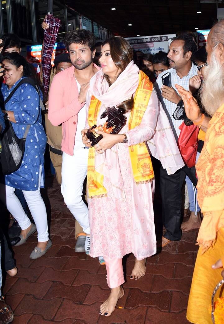 मंदिर के बाहर भारी भीड़ के बीच यहां हिमेश पत्नी को बचाकर ले जाते भी दिखे.