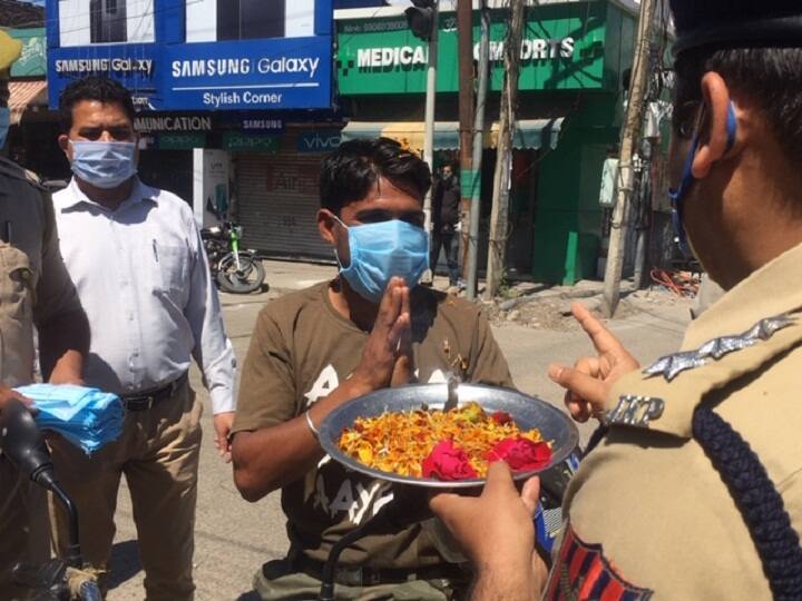 Jammu Police takes action against those who violate the lockdown ANN जम्मू: लॉकडाउन मनवाने के लिए पुलिस ने अपनाई गांधीगिरी, मास्क और सैनिटाइजर बांटे