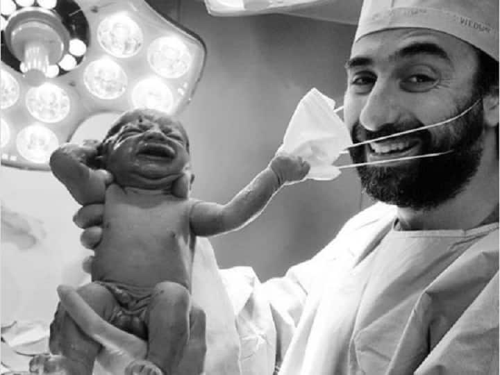 New Born Baby removing doctors mask becomes emblem of hope from coronavirus दुनिया में आते ही न्यू बॉर्न बेबी ने मचाया तहलका, सोशल मीडिया पर खूब वायरल हो रही है ये तस्वीर